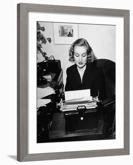 Actress Carole Lombard Typing While Holding Pencil Firmly in Her Mouth-Rex Hardy Jr.-Framed Premium Photographic Print