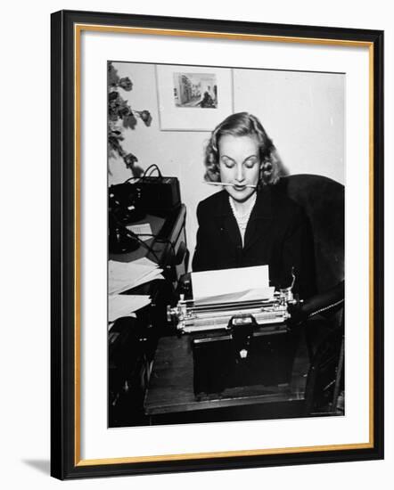 Actress Carole Lombard Typing While Holding Pencil Firmly in Her Mouth-Rex Hardy Jr.-Framed Premium Photographic Print