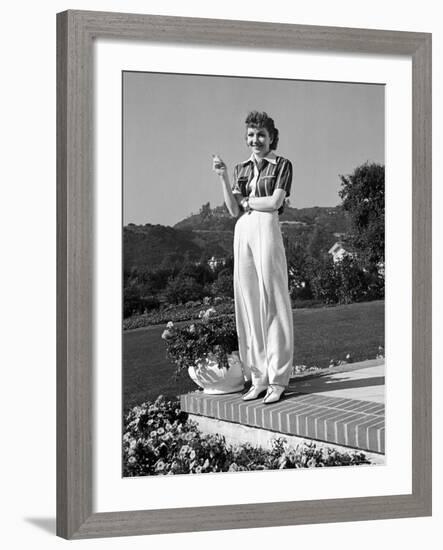 Actress Claudette Colbert Holding Cigarette as She Suns Herself on Terrace of Her Holmby Hills Home-Alfred Eisenstaedt-Framed Premium Photographic Print