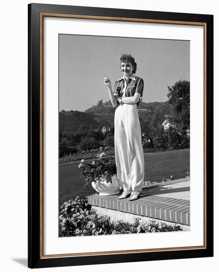 Actress Claudette Colbert Holding Cigarette as She Suns Herself on Terrace of Her Holmby Hills Home-Alfred Eisenstaedt-Framed Premium Photographic Print