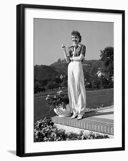 Actress Claudette Colbert Holding Cigarette as She Suns Herself on Terrace of Her Holmby Hills Home-Alfred Eisenstaedt-Framed Premium Photographic Print