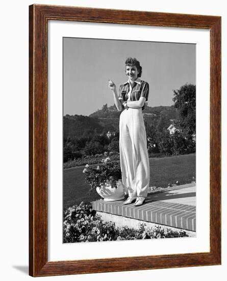 Actress Claudette Colbert Holding Cigarette as She Suns Herself on Terrace of Her Holmby Hills Home-Alfred Eisenstaedt-Framed Premium Photographic Print