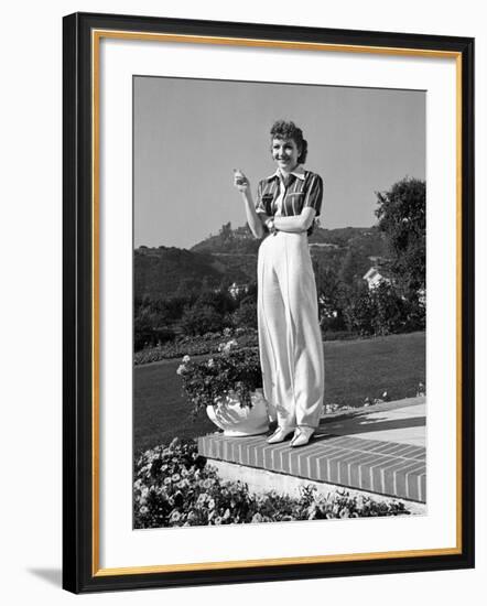 Actress Claudette Colbert Holding Cigarette as She Suns Herself on Terrace of Her Holmby Hills Home-Alfred Eisenstaedt-Framed Premium Photographic Print