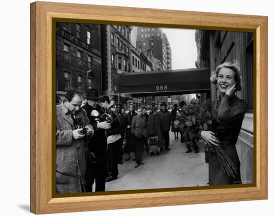 Actress Grace Kelly in Casual Pose with Armful of Roses Standing on Sidewalk During Shopping Trip-Lisa Larsen-Framed Premier Image Canvas