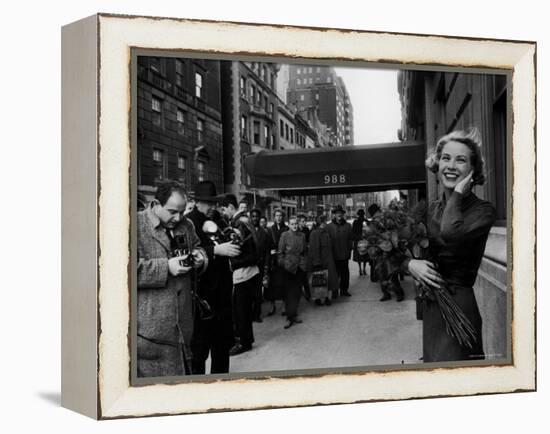 Actress Grace Kelly in Casual Pose with Armful of Roses Standing on Sidewalk During Shopping Trip-Lisa Larsen-Framed Premier Image Canvas