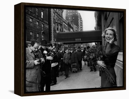 Actress Grace Kelly in Casual Pose with Armful of Roses Standing on Sidewalk During Shopping Trip-Lisa Larsen-Framed Premier Image Canvas