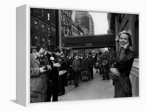 Actress Grace Kelly in Casual Pose with Armful of Roses Standing on Sidewalk During Shopping Trip-Lisa Larsen-Framed Premier Image Canvas