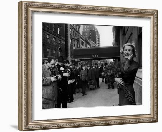 Actress Grace Kelly in Casual Pose with Armful of Roses Standing on Sidewalk During Shopping Trip-Lisa Larsen-Framed Premium Photographic Print