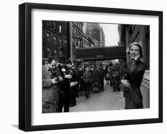 Actress Grace Kelly in Casual Pose with Armful of Roses Standing on Sidewalk During Shopping Trip-Lisa Larsen-Framed Premium Photographic Print