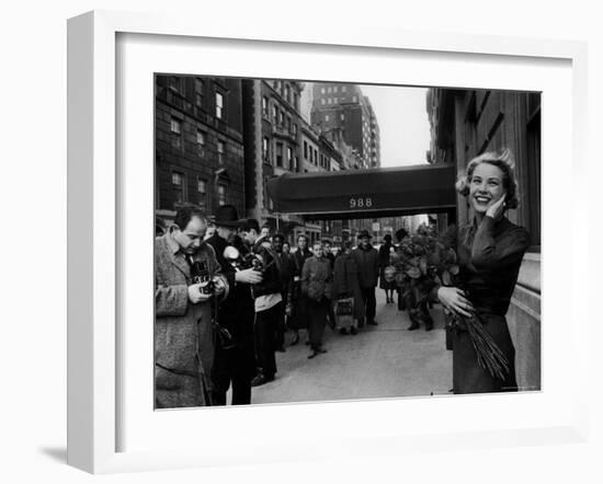 Actress Grace Kelly in Casual Pose with Armful of Roses Standing on Sidewalk During Shopping Trip-Lisa Larsen-Framed Premium Photographic Print