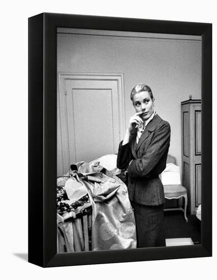 Actress Grace Kelly Packing Clothing Prior to Her Wedding to Prince Rainier-Lisa Larsen-Framed Premier Image Canvas
