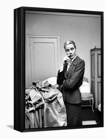 Actress Grace Kelly Packing Clothing Prior to Her Wedding to Prince Rainier-Lisa Larsen-Framed Premier Image Canvas