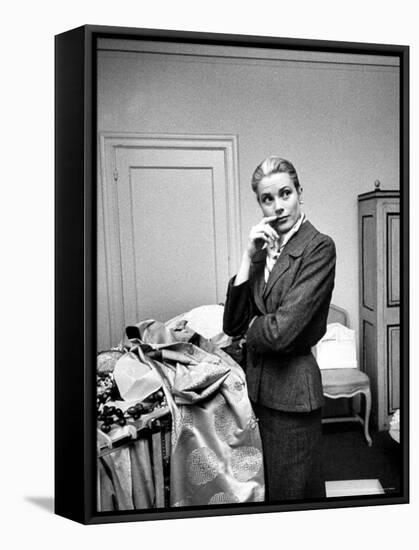 Actress Grace Kelly Packing Clothing Prior to Her Wedding to Prince Rainier-Lisa Larsen-Framed Premier Image Canvas