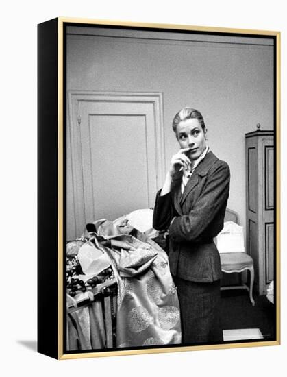 Actress Grace Kelly Packing Clothing Prior to Her Wedding to Prince Rainier-Lisa Larsen-Framed Premier Image Canvas