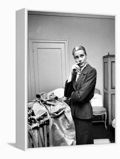 Actress Grace Kelly Packing Clothing Prior to Her Wedding to Prince Rainier-Lisa Larsen-Framed Premier Image Canvas