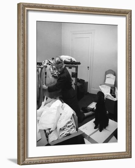 Actress Grace Kelly Packing for Wedding to Prince Rainer of Monaco While Pet Poodle Looks On-Lisa Larsen-Framed Premium Photographic Print