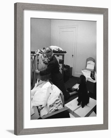 Actress Grace Kelly Packing for Wedding to Prince Rainer of Monaco While Pet Poodle Looks On-Lisa Larsen-Framed Premium Photographic Print