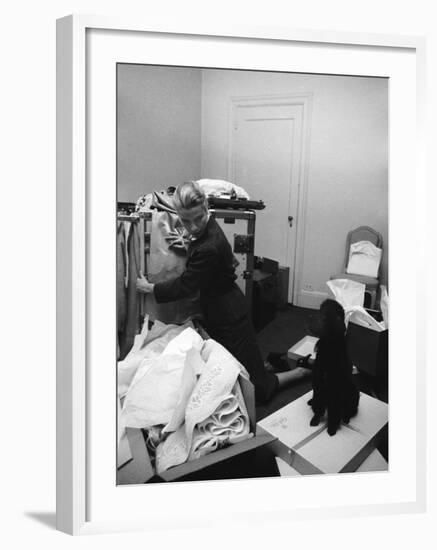 Actress Grace Kelly Packing for Wedding to Prince Rainer of Monaco While Pet Poodle Looks On-Lisa Larsen-Framed Premium Photographic Print