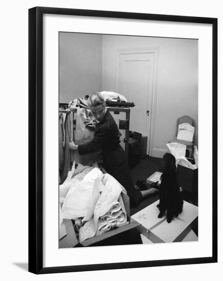 Actress Grace Kelly Packing for Wedding to Prince Rainer of Monaco While Pet Poodle Looks On-Lisa Larsen-Framed Premium Photographic Print