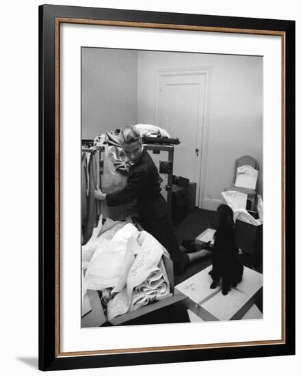 Actress Grace Kelly Packing for Wedding to Prince Rainer of Monaco While Pet Poodle Looks On-Lisa Larsen-Framed Premium Photographic Print