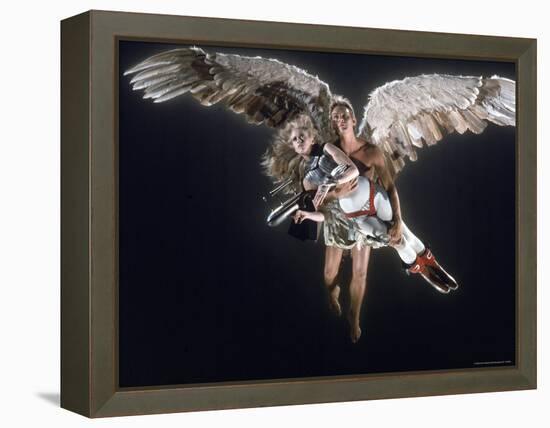 Actress Jane Fonda Being Carried by Guardian Angel in a Scene from Roger Vadim's Film "Barbarella"-Carlo Bavagnoli-Framed Premier Image Canvas