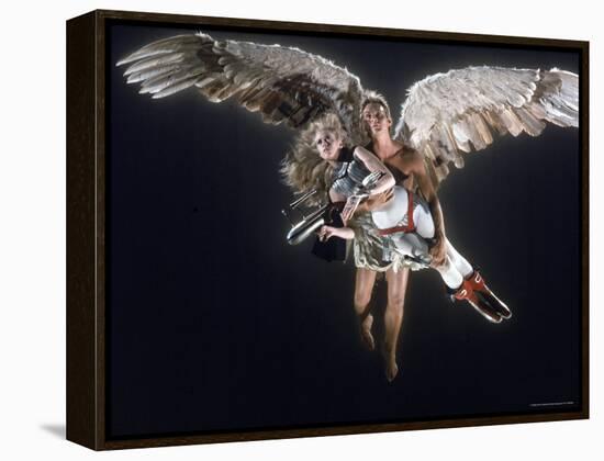 Actress Jane Fonda Being Carried by Guardian Angel in a Scene from Roger Vadim's Film "Barbarella"-Carlo Bavagnoli-Framed Premier Image Canvas