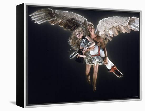 Actress Jane Fonda Being Carried by Guardian Angel in a Scene from Roger Vadim's Film "Barbarella"-Carlo Bavagnoli-Framed Premier Image Canvas