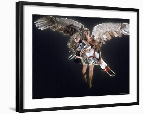 Actress Jane Fonda Being Carried by Guardian Angel in a Scene from Roger Vadim's Film "Barbarella"-Carlo Bavagnoli-Framed Premium Photographic Print