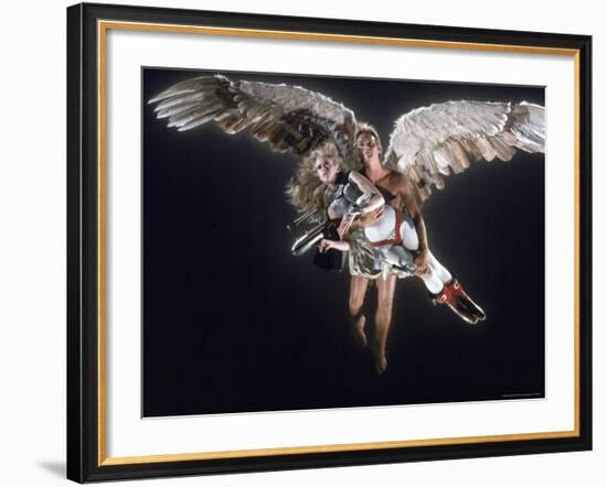 Actress Jane Fonda Being Carried by Guardian Angel in a Scene from Roger Vadim's Film "Barbarella"-Carlo Bavagnoli-Framed Premium Photographic Print