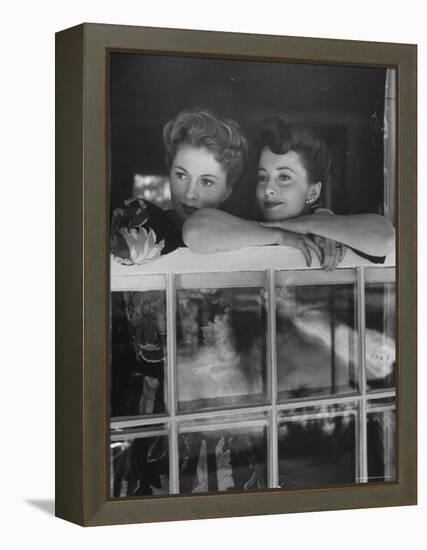 Actress Joan Fontaine with Actress Sister Olivia de Havilland Looking Out of Open Window at Home-Bob Landry-Framed Premier Image Canvas