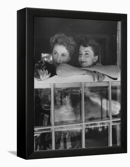 Actress Joan Fontaine with Actress Sister Olivia de Havilland Looking Out of Open Window at Home-Bob Landry-Framed Premier Image Canvas