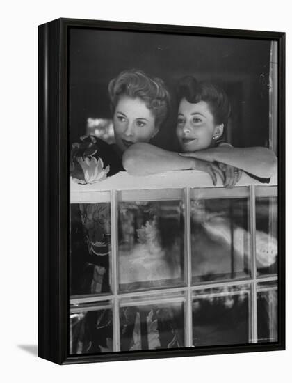 Actress Joan Fontaine with Actress Sister Olivia de Havilland Looking Out of Open Window at Home-Bob Landry-Framed Premier Image Canvas