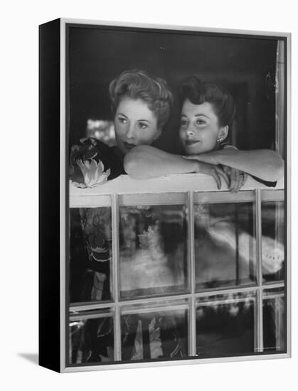 Actress Joan Fontaine with Actress Sister Olivia de Havilland Looking Out of Open Window at Home-Bob Landry-Framed Premier Image Canvas