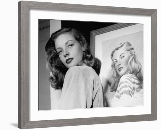 Actress Lauren Bacall Posing in Front of Portrait Drawing of Herself in Suite at the Gotham Hotel-Nina Leen-Framed Premium Photographic Print