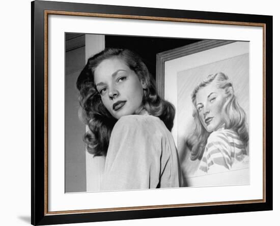 Actress Lauren Bacall Posing in Front of Portrait Drawing of Herself in Suite at the Gotham Hotel-Nina Leen-Framed Premium Photographic Print