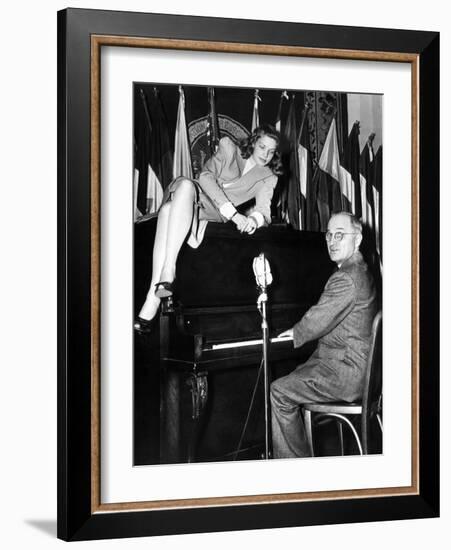 Actress Lauren Bacall Sits Atop the Piano While Vice President Harry Truman Plays-null-Framed Photo