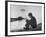 Actress Mia Farrow Pensively Sitting on Rocky Shore of Lake Geneva as Passenger Boat Passes By-Bill Eppridge-Framed Premium Photographic Print