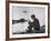 Actress Mia Farrow Pensively Sitting on Rocky Shore of Lake Geneva as Passenger Boat Passes By-Bill Eppridge-Framed Premium Photographic Print