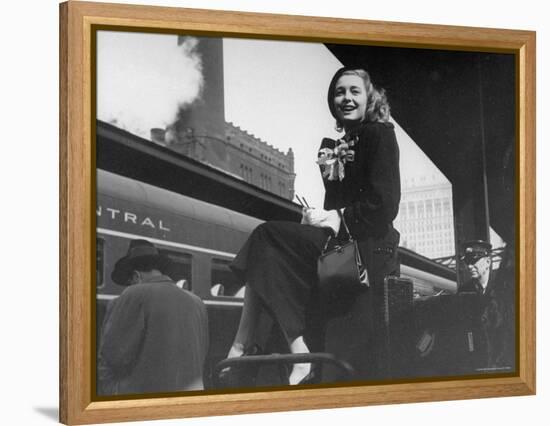 Actress Patricia Neal Sitting on Her Luggage on the Platform of a Train Station During a Stopover-Ed Clark-Framed Premier Image Canvas