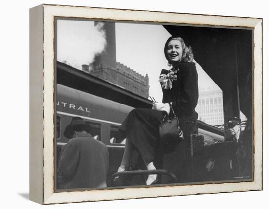 Actress Patricia Neal Sitting on Her Luggage on the Platform of a Train Station During a Stopover-Ed Clark-Framed Premier Image Canvas