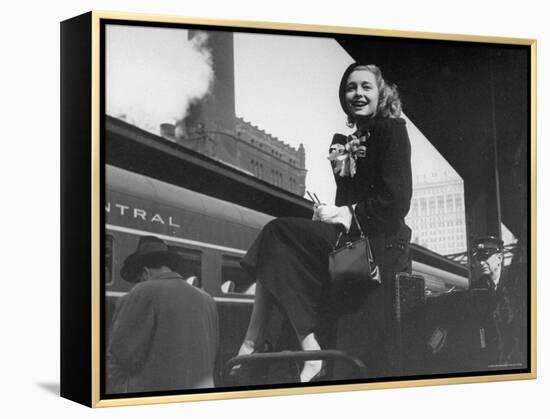 Actress Patricia Neal Sitting on Her Luggage on the Platform of a Train Station During a Stopover-Ed Clark-Framed Premier Image Canvas