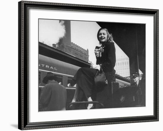 Actress Patricia Neal Sitting on Her Luggage on the Platform of a Train Station During a Stopover-Ed Clark-Framed Premium Photographic Print