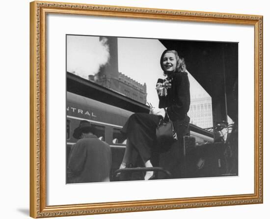 Actress Patricia Neal Sitting on Her Luggage on the Platform of a Train Station During a Stopover-Ed Clark-Framed Premium Photographic Print