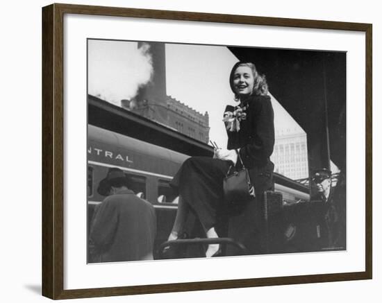 Actress Patricia Neal Sitting on Her Luggage on the Platform of a Train Station During a Stopover-Ed Clark-Framed Premium Photographic Print