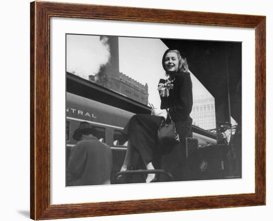 Actress Patricia Neal Sitting on Her Luggage on the Platform of a Train Station During a Stopover-Ed Clark-Framed Premium Photographic Print