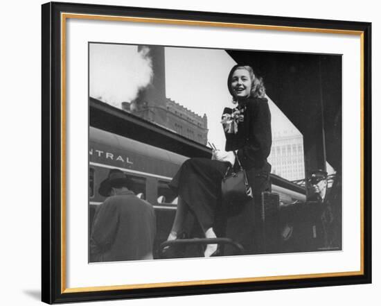 Actress Patricia Neal Sitting on Her Luggage on the Platform of a Train Station During a Stopover-Ed Clark-Framed Premium Photographic Print