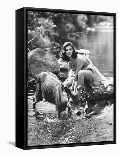 Actress Pier Angeli, Clad in Strapless Chiffon Party Dress Sitting on a Rock in a Pond-Allan Grant-Framed Premier Image Canvas
