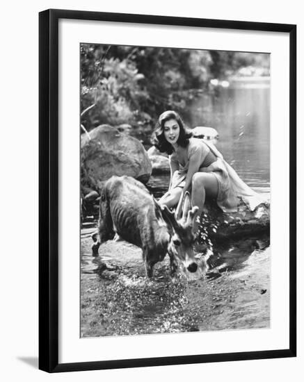 Actress Pier Angeli, Clad in Strapless Chiffon Party Dress Sitting on a Rock in a Pond-Allan Grant-Framed Premium Photographic Print
