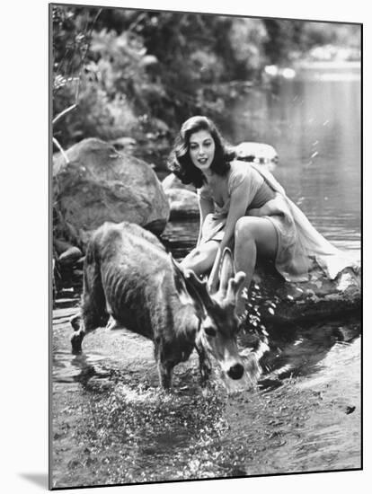 Actress Pier Angeli, Clad in Strapless Chiffon Party Dress Sitting on a Rock in a Pond-Allan Grant-Mounted Premium Photographic Print