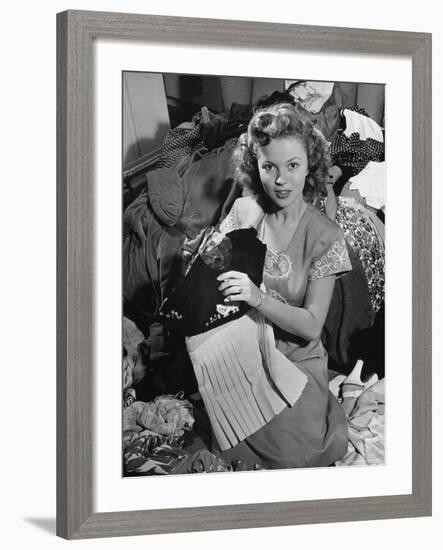 Actress Shirley Temple, Gathering Her Unwanted Clothes Together to Donate to a Clothing Drive-Martha Holmes-Framed Premium Photographic Print